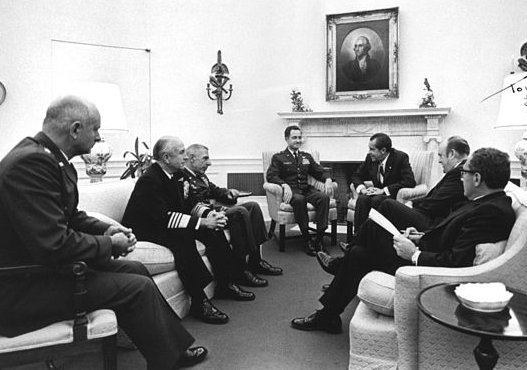 President Nixon meets with military leaders in the Oval Office with Melvin Laird, secretary of defense; and Henry Kissinger, national security adviser.